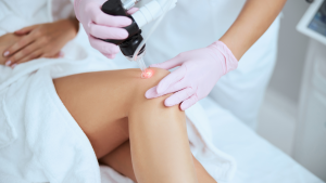 a person getting laser treatment on their knee