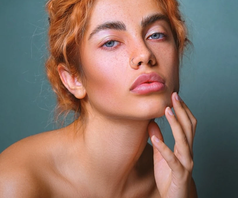 a woman with red hair and blue eyes