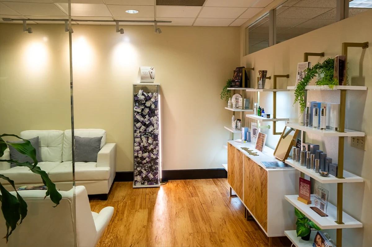 Interior of a room with a white couch, shelves, and decorative items against light walls